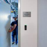 Men walking through a door into a mechanics shop