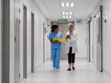 a nurse and a doctor walking through a hospital corridor