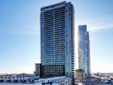 Image of The MET condo tower in Vaughan, Ontario against a blue sky background