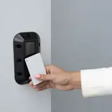 image of somebody badging against a reader with a vandal resistant cover
