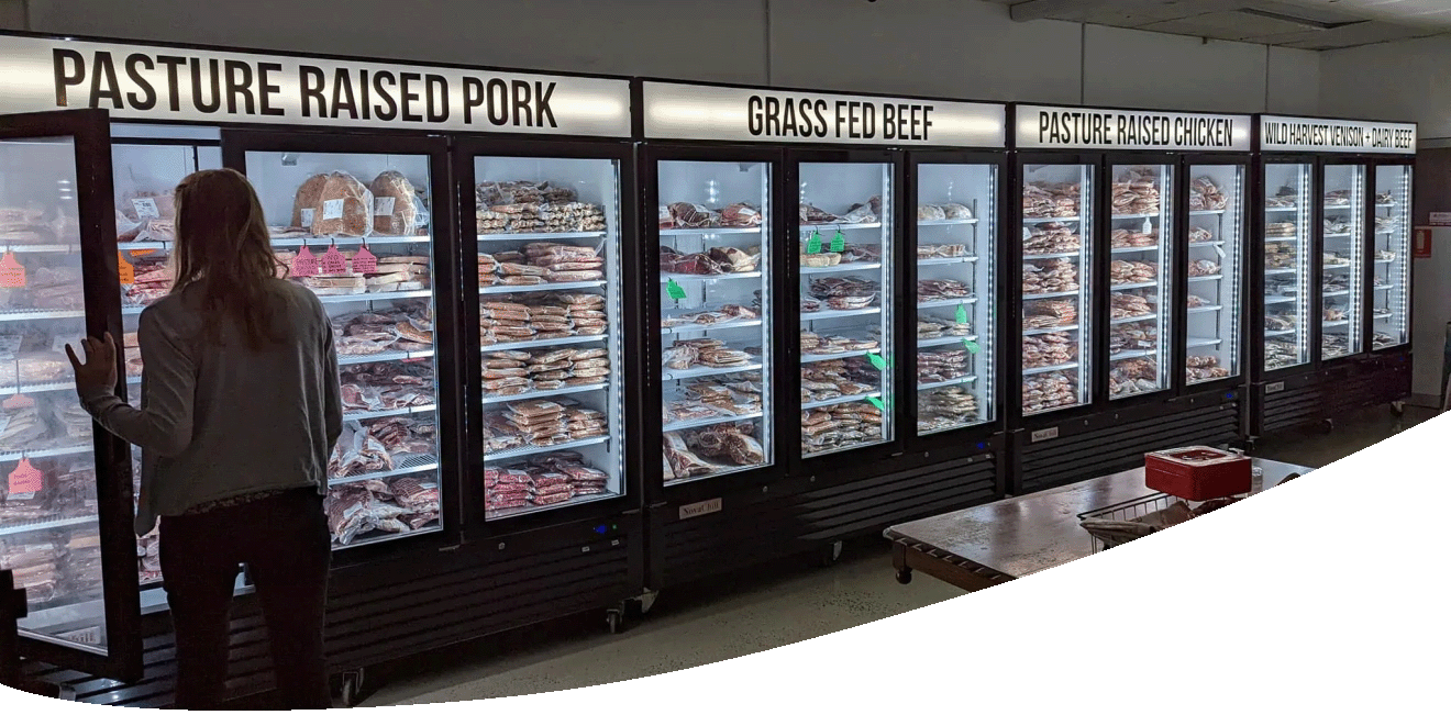 Interior view of Wolki Butchery with women opening a fridge door