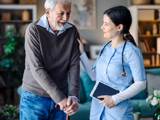 a staff member talking to a patient in an aged care facility