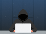 Hooded person at laptop