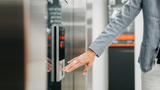 Woman pressing an elevator button